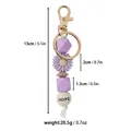 Vue détaillée du porte-clés en silicone marguerite violette avec poids et dimensions - Style Lettre HOPE / Violet