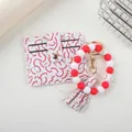 Detailed shot of baseball pattern card holder and silicone bead wristlet keychain - Red White