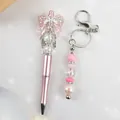 Elegant pink beaded pen and keychain set with bow and crystal rhinestones - Ballpoint Pen / Pink