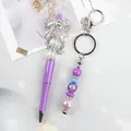 Handmade purple beaded ballpoint pen and keychain set with crystal bow decoration - Ballpoint Pen / Purple