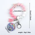 Pink silicone bead keychain bracelet with mama floral pendant and cross charm - Pink