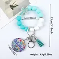 Silicone bead keychain bracelet with cross charm, teal tassel, and floral Mama tag detail - Emerald Green