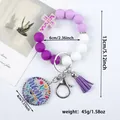 Purple and white silicone bead wristlet keychain with Mama floral charm and tassel - Violet