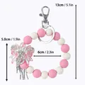 Silikonperlen-Schlüsselanhänger in Pink und Weiß mit einer eleganten Strass-Schleife - Schleifenstil / Rosa