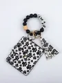 Detail view of silicone bead bracelet keychain with paw print card holder and tassel - Cat Paw Style