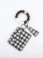 Detail view of checkered card holder attached to a silicone bead wristlet keychain - Black and White Grid Style