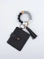 Detail view of black PU card holder with silicone bead wristlet and tassel keychain - Solid Black Style