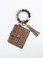 Close-up of leopard print card holder with silicone bead wristlet and tassel - Dark Leopard Print Style