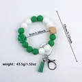 Green and white silicone beaded keychain bracelet with tassel and leaf charm - Green