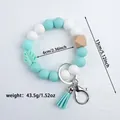 Mint green and white silicone beaded keychain bracelet with tassel and leaf charm. - Emerald Green