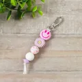 Llavero de cuentas de silicona con cara sonriente rosa y flor para bolsos de mano - Estilo Colgante (K-1567) / Púrpura
