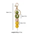 Porte-clés en perles de silicone avec breloque marguerite et bois, longueur 13cm. - Marguerite Sauvage / Vert