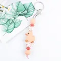 Cute silicone little yellow duck keychain featuring pink beads and patterned accents - Pink