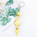 Cute yellow silicone duck keychain featuring floral beads and a sturdy silver clasp - Light Yellow