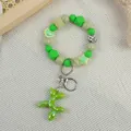 Cute green beaded keychain bracelet featuring a glossy balloon dog charm. - Green