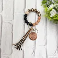 Detail view of silicone bead keychain with leopard print, tassel, and Mama wood charm - Brown Style (K-1016)