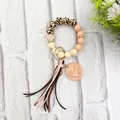 Detail of leopard print wood beads and 'mama' engraved heart tag wristlet keychain - Dusty Rose Style (K-1016)