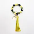 Detailed view of the UV-plated zebra stripe beaded wristlet with a yellow tassel. - Yellow