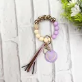 Close-up of leopard print wood and silicone bead wristlet keychain with purple tassel - Purple Style (K-1016)