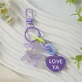 Purple heart-shaped keychain featuring 'LOVE YA' text and a cute balloon dog charm for bags. - Purple