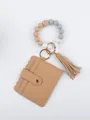 Detailed view of the stylish tan PU leather card holder with beaded bracelet and tassel accessory - Antique Bronze Style