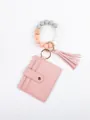 Detailed view of pink PU leather card holder with silicone bead wristlet and decorative tassel - Pink Style