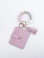 Close-up of lavender PU leather card holder with beaded silicone wristlet and tassel. - Lotus Pink Style