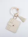Close-up of beige PU leather card wallet with beaded wristlet and tassel detail - Cream White Style