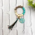Macro detail of leopard print bead keychain with heart charm and velvet tassel. - Green Style (K-1016)