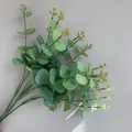 Detailed macro view of artificial eucalyptus stems with realistic silk-screened leaves. - 16 Branches Eucalyptus (YD202230) / Silk Screen Green