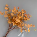 High-quality detail of artificial orange eucalyptus branches with realistic leaf textures - 16 Branches Eucalyptus (YD202230) / Silk Screen Autumn Yellow