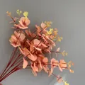 Close-up of artificial eucalyptus leaves with peach and yellow gradient colors - 16 Branches Eucalyptus (YD202230) / Non-woven Pink