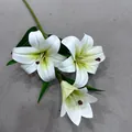 Detailed view of artificial white lily blossoms with realistic green leaves and buds. - Lily (Green Center)