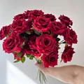 Close-up of a large bouquet of deep red artificial Floyd roses held by hand - 3-Head Rose / Red