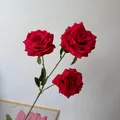 Detailed view of vibrant red artificial Floyd roses with realistic green leaves and stems. - 3-Head Rose / Red