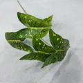 Detailed macro view of 3D artificial Alocasia leaves with realistic yellow spot patterns - Caladium Leaf Style 1