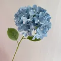 Close-up view of a 20cm blue artificial hydrangea stem with realistic petals - Fog Blue