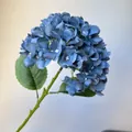 High-definition close-up of a blue artificial hydrangea with realistic fabric petals - Haze Blue