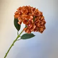 Close-up of a single stem burnt orange artificial hydrangea flower for wedding decor - Burnt Orange