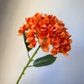 Detailed view of a vibrant orange artificial hydrangea flower for home or wedding decor. - Orange