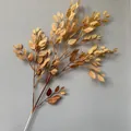 Detailed view of spray-colored artificial banyan leaves with autumn tones. - Khaki