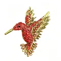 Exquisite detailed macro view of vibrant red rhinestone hummingbird brooch jewelry. - Antique Gold And Red