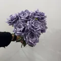 Detailed view of a 9-head European style artificial purple rose bouquet held by hand - 9 Heads Bouquet / Deep purple