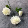Detail view of three white artificial silk flower heads with green leaves. - White