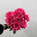 Close-up detail of a vibrant magenta 9-head silk rose bouquet held against a plain wall - 9 Heads Bouquet / Rose Pink
