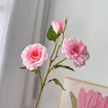 Macro view of pink artificial lisianthus flowers featuring delicate petals and green stems - 3-Head Pink Eustoma