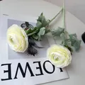 Detailed view of white artificial Ranunculus flowers with realistic flocked green stems. - Milk White