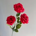 Detailed view of three red silk roses featuring realistic faux water droplets on the petals. - Red