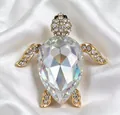 Close-up of a sparkling sea turtle brooch with a large iridescent crystal shell - Rainbow
