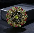 Detailed view of luxury vintage wreath brooch with red and green rhinestones on gold - Colorful